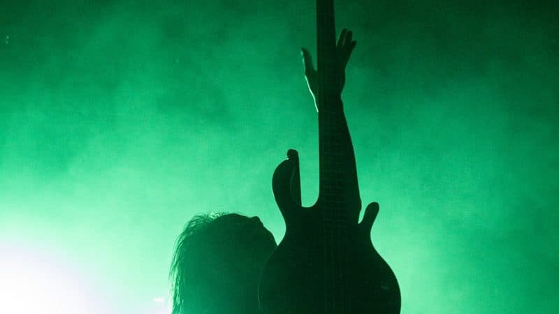 silhouette of people raising hands