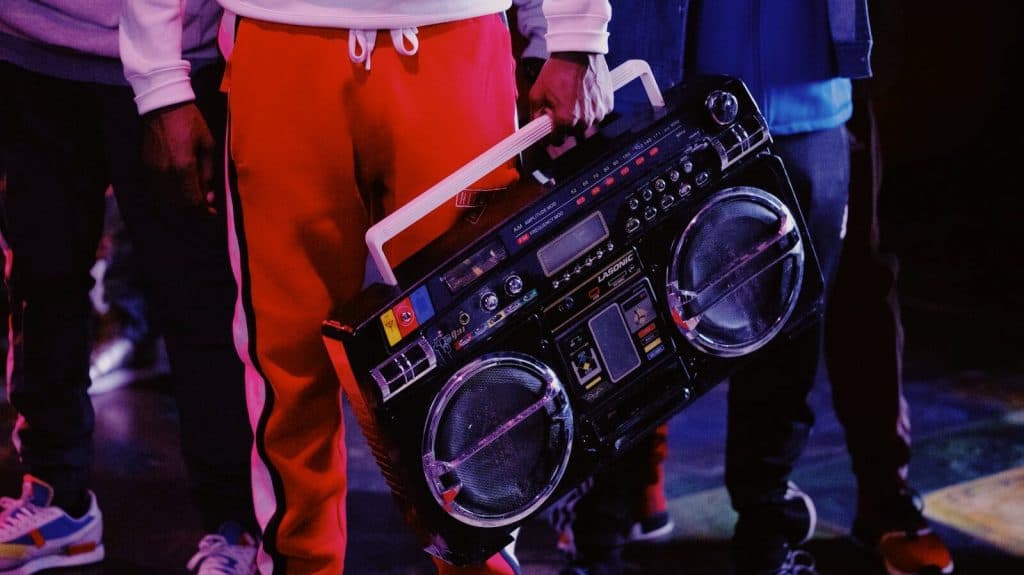 man in red jacket holding black dj controller